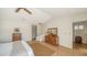 Bright main bedroom featuring a ceiling fan, wooden floors, neutral walls, and closet doors at 3455 Flamingo Ave, Sarasota, FL 34242