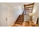 Rustic wooden stairway with a white door and tile flooring at 3455 Flamingo Ave, Sarasota, FL 34242
