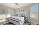 This bedroom features a coastal decor and large windows with plantation shutters at 3568 Santa Caterina Blvd, Bradenton, FL 34211