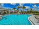 A sparkling community pool with lounge chairs and palm trees, perfect for relaxation and enjoying the Florida sunshine at 3568 Santa Caterina Blvd, Bradenton, FL 34211