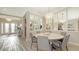 An elegant dining room features mirrored walls, chandelier lighting and seating for six at 3568 Santa Caterina Blvd, Bradenton, FL 34211