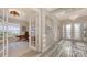 Welcoming home foyer with office entrance featuring an elegant chandelier and transom windows at 3568 Santa Caterina Blvd, Bradenton, FL 34211