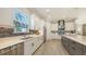 Spacious kitchen featuring stainless appliances, white cabinetry, gray backsplash, and a large island at 3568 Santa Caterina Blvd, Bradenton, FL 34211
