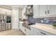 Well-equipped kitchen featuring stainless appliances, white cabinetry, and stylish tile backsplash at 3568 Santa Caterina Blvd, Bradenton, FL 34211