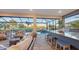 Inviting screened-in lanai with a luxurious pool, spa, and full outdoor kitchen overlooking the golf course at 3568 Santa Caterina Blvd, Bradenton, FL 34211
