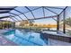 Stunning pool and spa area with waterfall features, surrounded by lush landscaping and a picturesque golf course view at 3568 Santa Caterina Blvd, Bradenton, FL 34211