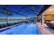 Stunning screened pool and spa with water feature overlooking the lake and golf course at 3568 Santa Caterina Blvd, Bradenton, FL 34211