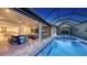 Beautiful transition from indoor to outdoor living; the lanai features a pool, outdoor kitchen, and bar area at 3568 Santa Caterina Blvd, Bradenton, FL 34211