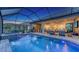 Beautiful screened in pool and spa with an outdoor kitchen and seating area at 3568 Santa Caterina Blvd, Bradenton, FL 34211