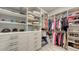 This walk-in closet is equipped with custom shelving and built-in drawers at 3568 Santa Caterina Blvd, Bradenton, FL 34211