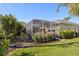 Expansive backyard featuring a screened-in pool, lush landscaping, and a well-maintained lawn with partial view of home at 3752 Summerwind Cir, Bradenton, FL 34209