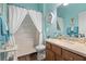 Bright bathroom featuring a white shower curtain, vanity, and coastal-themed decorations at 3752 Summerwind Cir, Bradenton, FL 34209