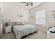 Relaxing bedroom with a queen-sized bed, charming beach-themed decor, and a ceiling fan at 3752 Summerwind Cir, Bradenton, FL 34209