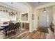 Open dining room boasts decorative furnishings, artwork, modern chandelier, and wood-look flooring at 3752 Summerwind Cir, Bradenton, FL 34209