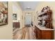 Inviting foyer features wood-look floors, antique furnishings, decorative art and a view of the front door at 3752 Summerwind Cir, Bradenton, FL 34209