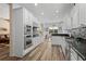 Modern kitchen with white cabinets, stainless steel appliances, granite countertops, and hardwood floors at 3752 Summerwind Cir, Bradenton, FL 34209