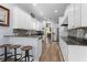 Bright, modern kitchen features a breakfast bar, stainless steel appliances, granite countertops, and stylish accents at 3752 Summerwind Cir, Bradenton, FL 34209