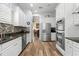 Contemporary kitchen featuring stainless steel appliances, granite countertops, and hardwood floors at 3752 Summerwind Cir, Bradenton, FL 34209