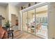 View from home's interior through sliding glass doors to the covered lanai, with outdoor seating and a private pool beyond at 3752 Summerwind Cir, Bradenton, FL 34209
