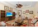 Cozy living room with hardwood floors, ceiling fan, comfortable seating, and a modern entertainment center at 3752 Summerwind Cir, Bradenton, FL 34209