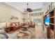 Bright living room features hardwood floors, ceiling fan, comfortable seating, and backyard access at 3752 Summerwind Cir, Bradenton, FL 34209