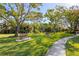 Scenic park with benches, lush greenery, palm trees and a pathway through landscaped grounds at 3752 Summerwind Cir, Bradenton, FL 34209