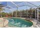 Screened-in pool and spa surrounded by trees, outdoor furniture, and a deck with access to the home at 3752 Summerwind Cir, Bradenton, FL 34209