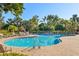 Resort-style community pool with lounge chairs and lush landscaping, set in a tropical environment at 3752 Summerwind Cir, Bradenton, FL 34209