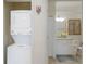 Neat bathroom, featuring a granite vanity, next to a laundry closet for added convenience at 3814 Scrub Creek Run, Lakewood Ranch, FL 34211