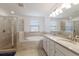 Spa-like bathroom featuring a double vanity, soaking tub, tiled shower, and large windows for natural light at 3814 Scrub Creek Run, Lakewood Ranch, FL 34211
