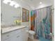 Well-lit bathroom with a modern vanity and a stylish shower curtain, creating a calming atmosphere at 3814 Scrub Creek Run, Lakewood Ranch, FL 34211