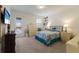 Cozy bedroom with neutral carpeting, a comfy queen bed, and sliding door access to outdoor pool at 3814 Scrub Creek Run, Lakewood Ranch, FL 34211
