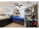Cozy bedroom features a blue bed, light wood floors, and lots of personality at 3814 Scrub Creek Run, Lakewood Ranch, FL 34211