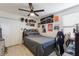 This bedroom features a gray bed, wood floors, and is decorated with posters at 3814 Scrub Creek Run, Lakewood Ranch, FL 34211