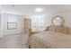 Large bedroom featuring wood-look floors, neutral decor, and bright natural light at 3814 Scrub Creek Run, Lakewood Ranch, FL 34211