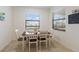 Bright breakfast nook with a table set for four and sunlit windows overlooking the backyard at 3814 Scrub Creek Run, Lakewood Ranch, FL 34211