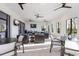 Well-lit community lounge with couches, tables, and ceiling fans at 3814 Scrub Creek Run, Lakewood Ranch, FL 34211