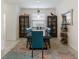 Elegant dining room featuring a long wooden table, stylish seating, and decorative display cabinets at 3814 Scrub Creek Run, Lakewood Ranch, FL 34211