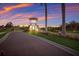 Guard house with a tile roof stands as a welcoming beacon, framed by manicured landscaping and tall palm trees at 3814 Scrub Creek Run, Lakewood Ranch, FL 34211