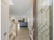 Inviting foyer with tile flooring and glass front door leads to the spacious living area with water view at 3814 Scrub Creek Run, Lakewood Ranch, FL 34211