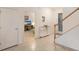 Light-filled foyer featuring tiled floors, a staircase, and a decorative entry door at 3814 Scrub Creek Run, Lakewood Ranch, FL 34211