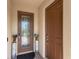 Front entryway with decorative glass door and sidelight featuring dark bronze hardware at 3814 Scrub Creek Run, Lakewood Ranch, FL 34211
