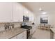 Modern kitchen featuring white cabinetry, stainless steel appliances, and granite countertops at 3814 Scrub Creek Run, Lakewood Ranch, FL 34211