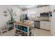 Bright kitchen with white cabinetry, stainless appliances, and a central kitchen island for extra counter space at 3814 Scrub Creek Run, Lakewood Ranch, FL 34211