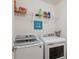 Well-organized laundry room featuring modern washer and dryer appliances at 3814 Scrub Creek Run, Lakewood Ranch, FL 34211