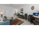 Inviting living room with tile floors, a blue leather sofa, plus a television and a workstation at 3814 Scrub Creek Run, Lakewood Ranch, FL 34211