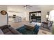 Bright living room flows into the modern kitchen, featuring a sliding glass door to the outdoor pool area at 3814 Scrub Creek Run, Lakewood Ranch, FL 34211