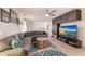 Spacious living room features a large sectional sofa and built-in entertainment center with a large flat-screen TV at 3814 Scrub Creek Run, Lakewood Ranch, FL 34211