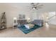 Cozy living room showcasing a boat-shaped bookshelf and comfortable seating on a vibrant rug at 3814 Scrub Creek Run, Lakewood Ranch, FL 34211
