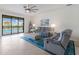 Comfortable living room with sliding glass doors to the pool area and plush seating at 3814 Scrub Creek Run, Lakewood Ranch, FL 34211